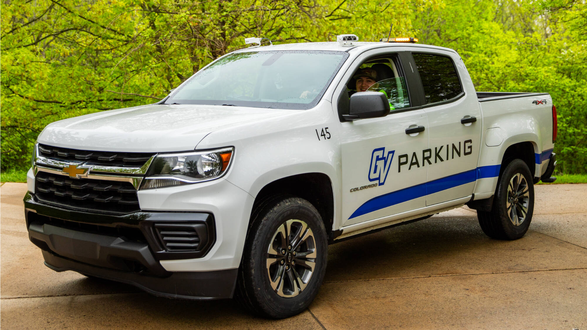 picture of gvsu parking truck by the trees
